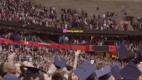 Graduates throw their caps in the air